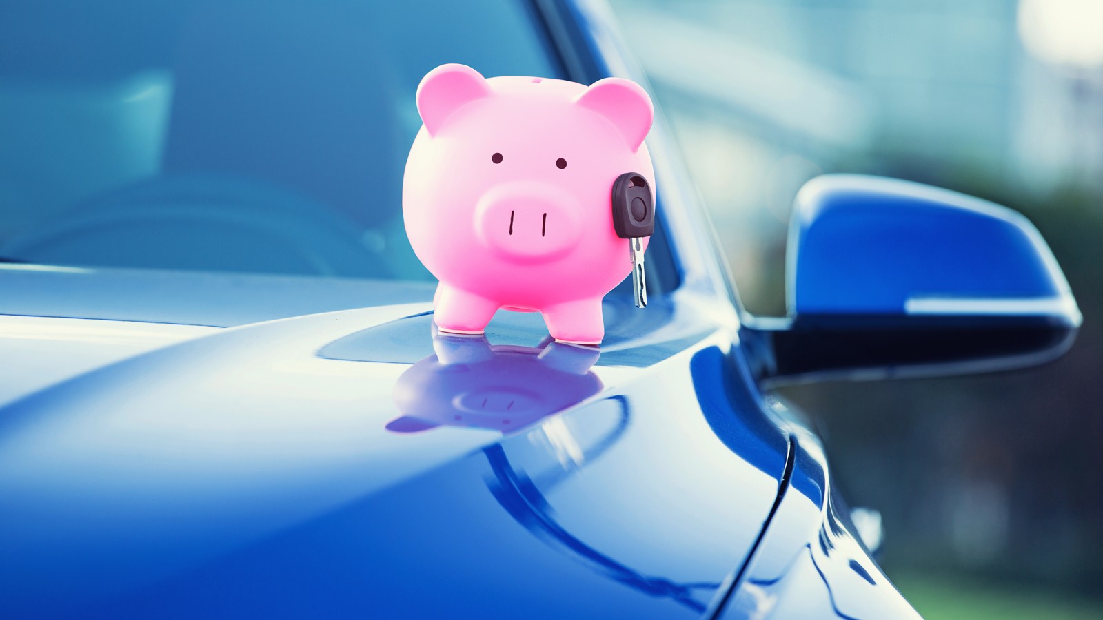new car with piggy bank, key on hood
