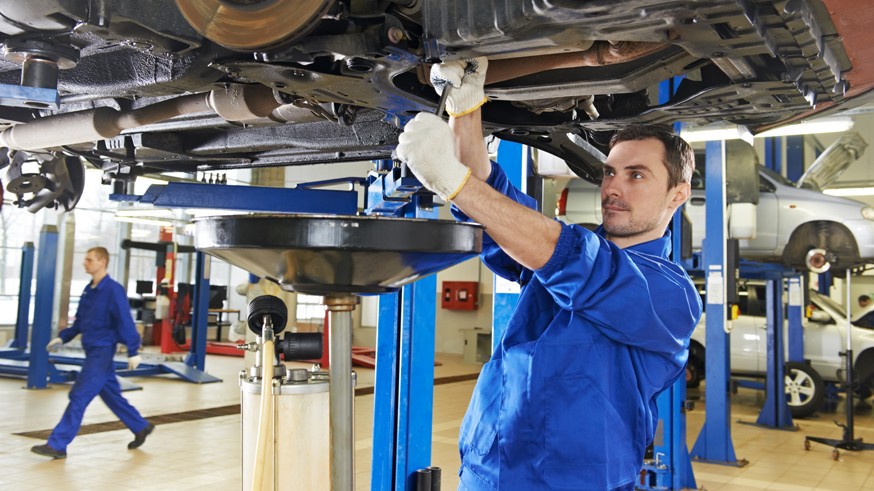 auto mechanic at car suspension repair work