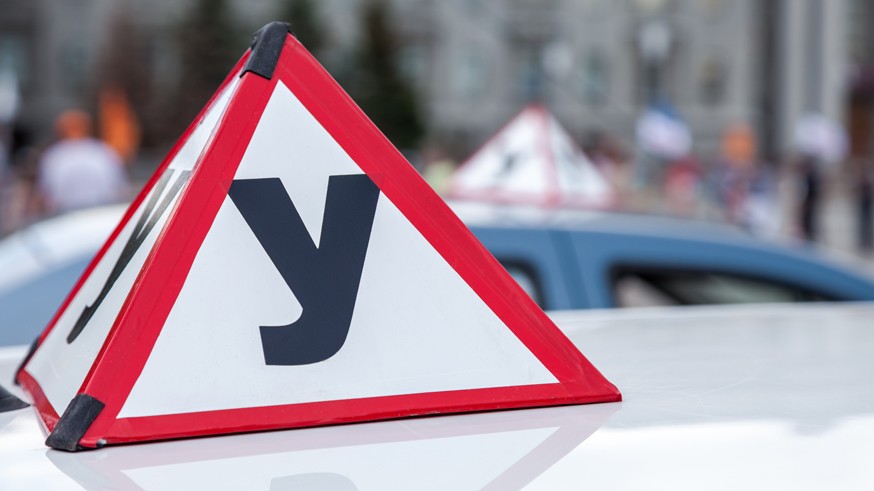 Sign of a Russian Driving School on top of the vehicle