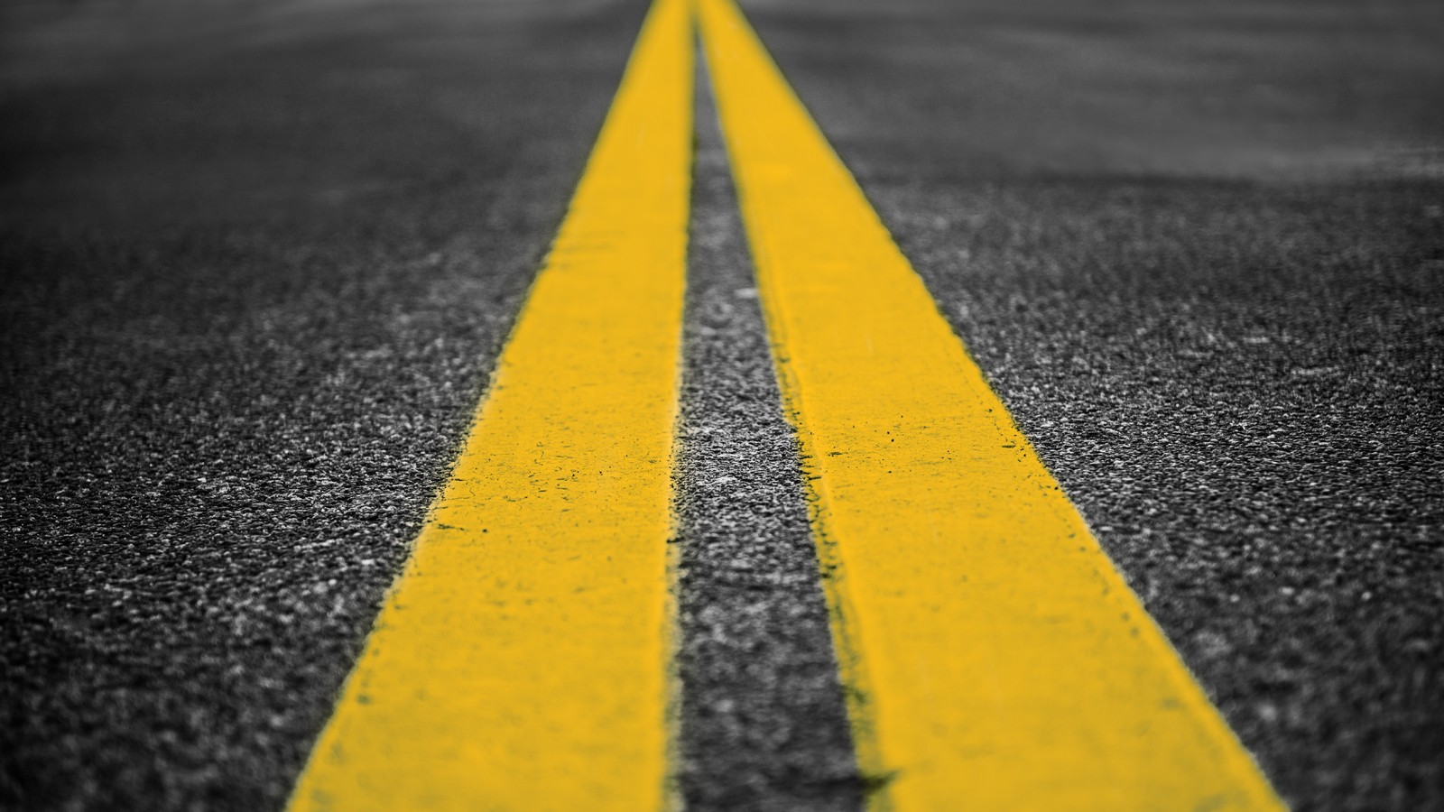 Asphalt highway with yellow markings lines on road background