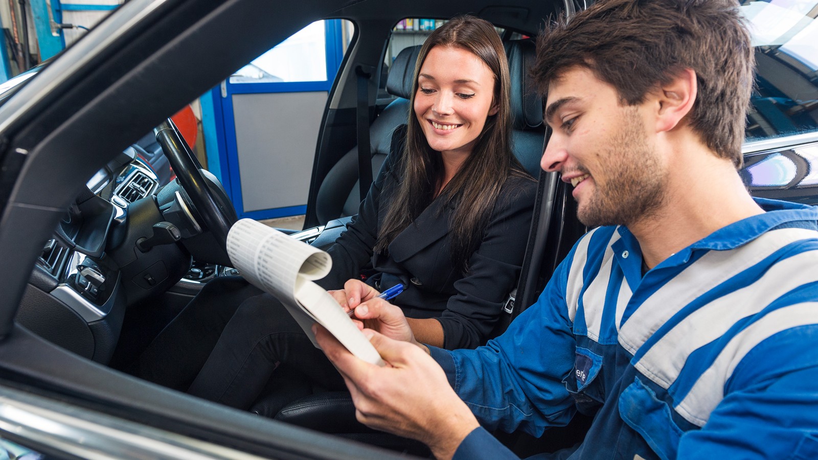 Car mechanic with customer