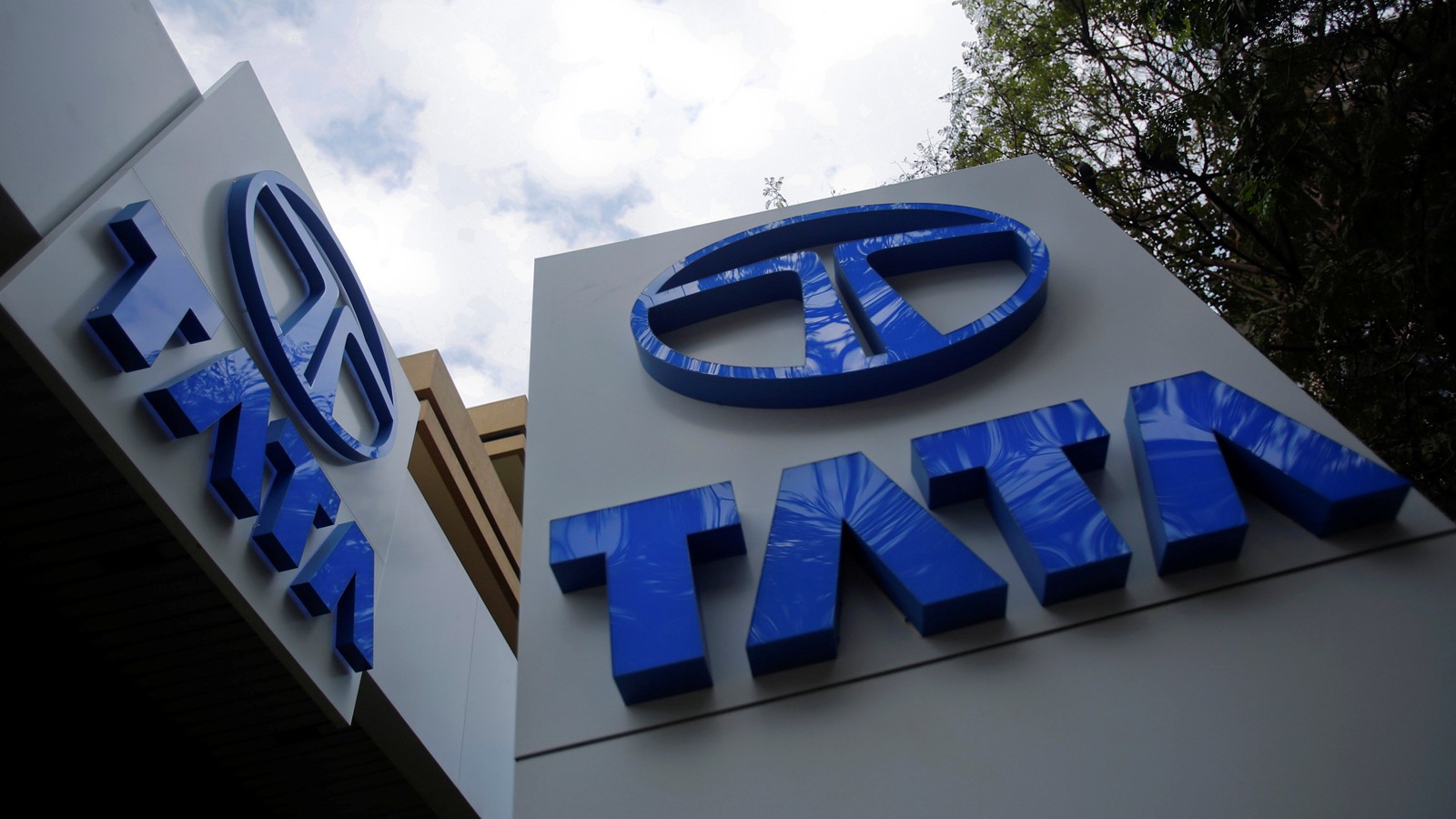Tata Motors logos are seen at their flagship showroom before the announcement of their Q3 results in Mumbai
