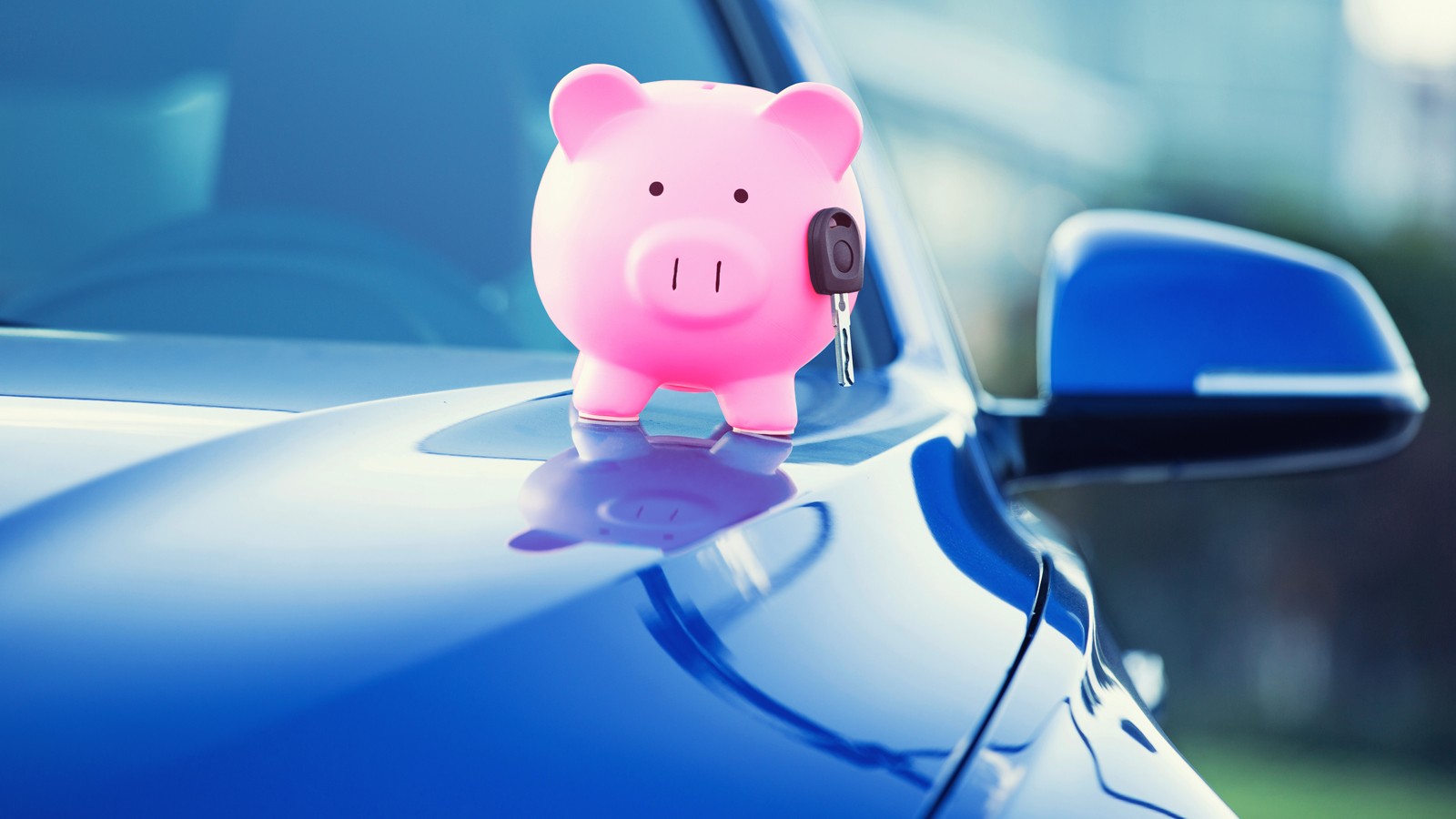 new car with piggy bank, key on hood