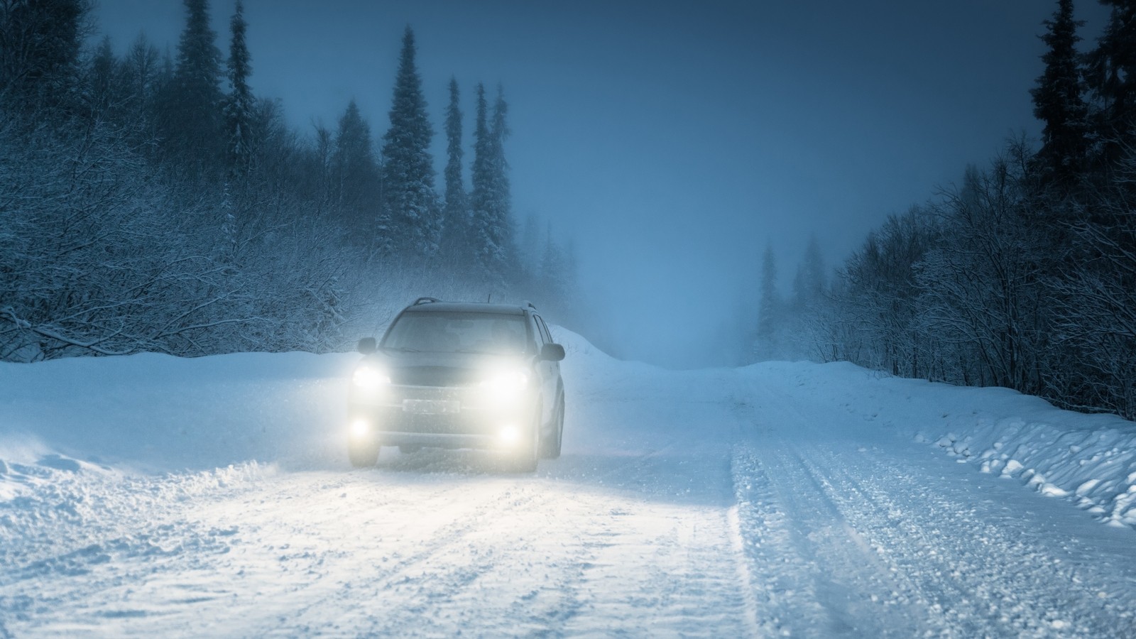 Car lights in winter Russian forest