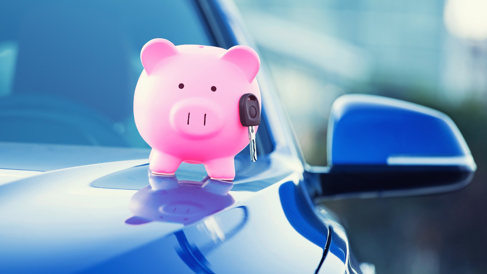 new car with piggy bank, key on hood