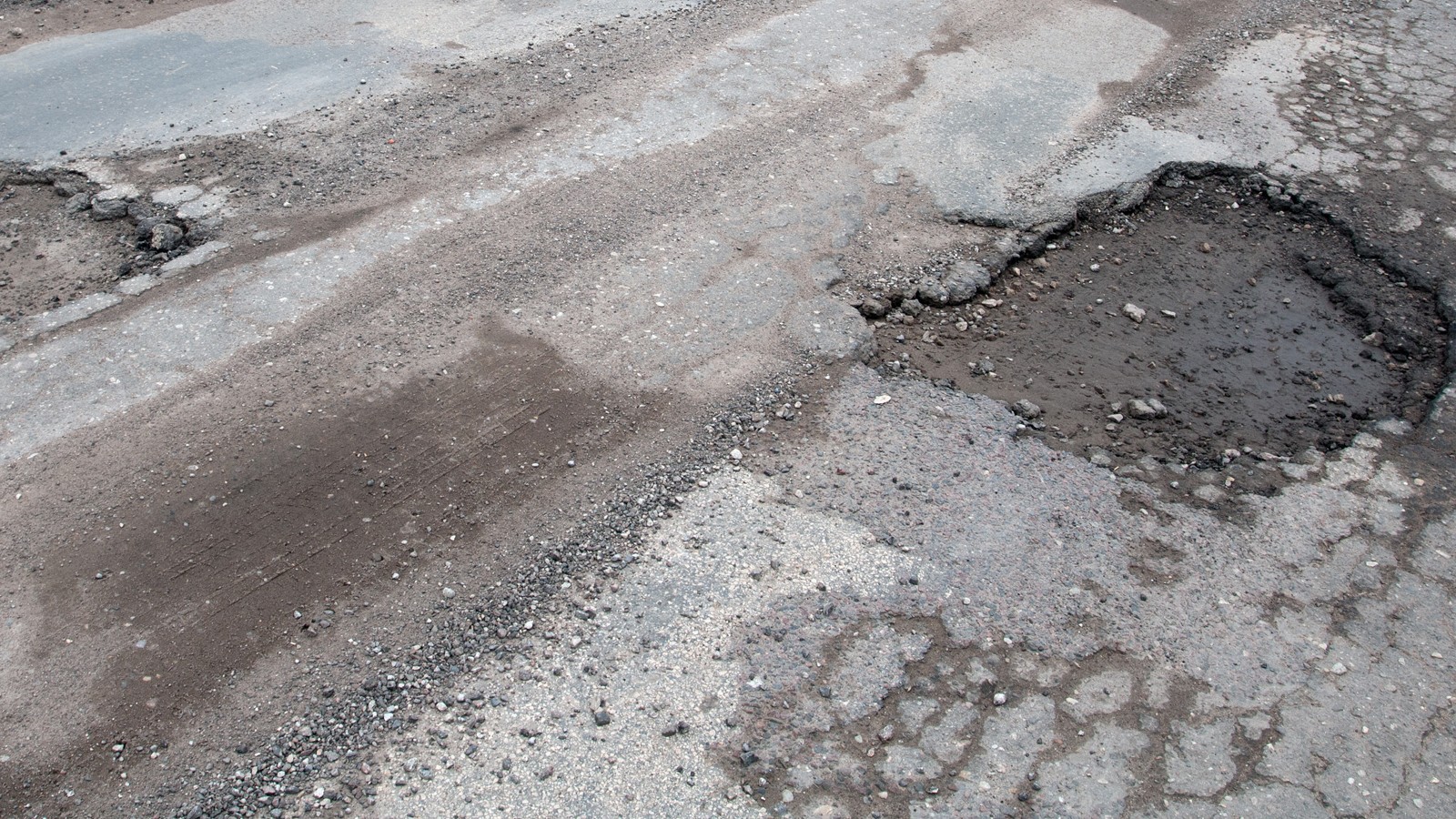 Damaged asphalt road after winter.