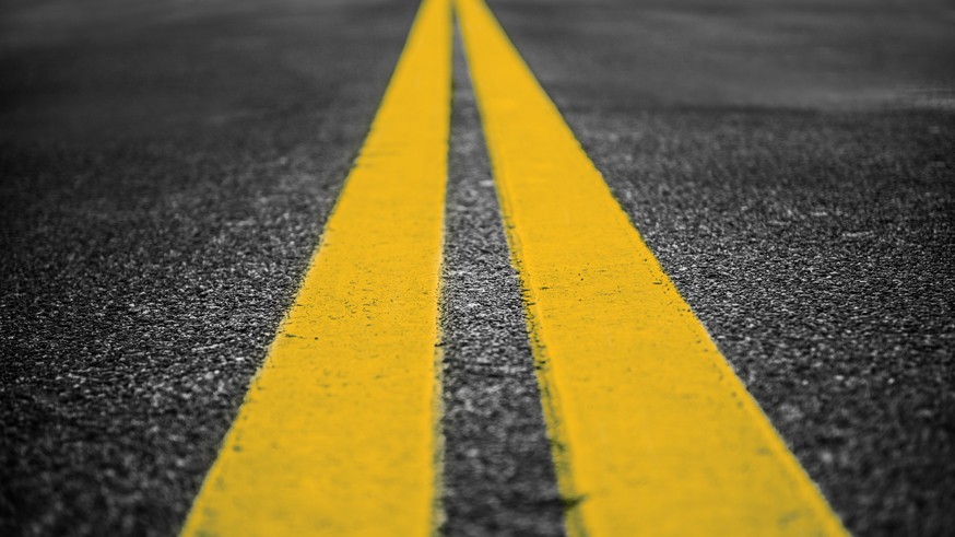Asphalt highway with yellow markings lines on road background