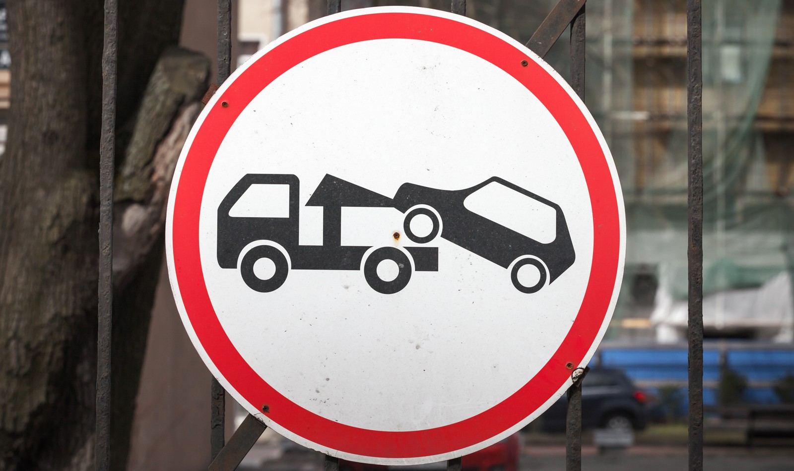 Evacuation on tow truck. Round road sign