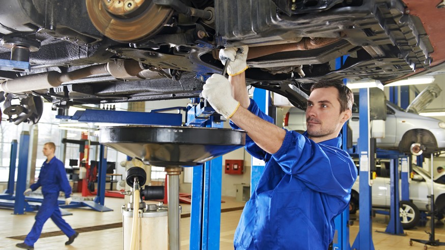 auto mechanic at car suspension repair work