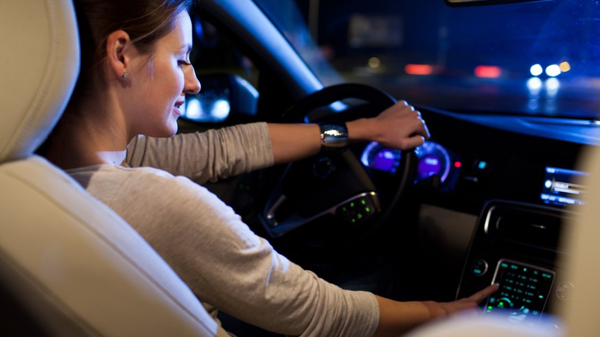 Woman driving his modern car at night in a city