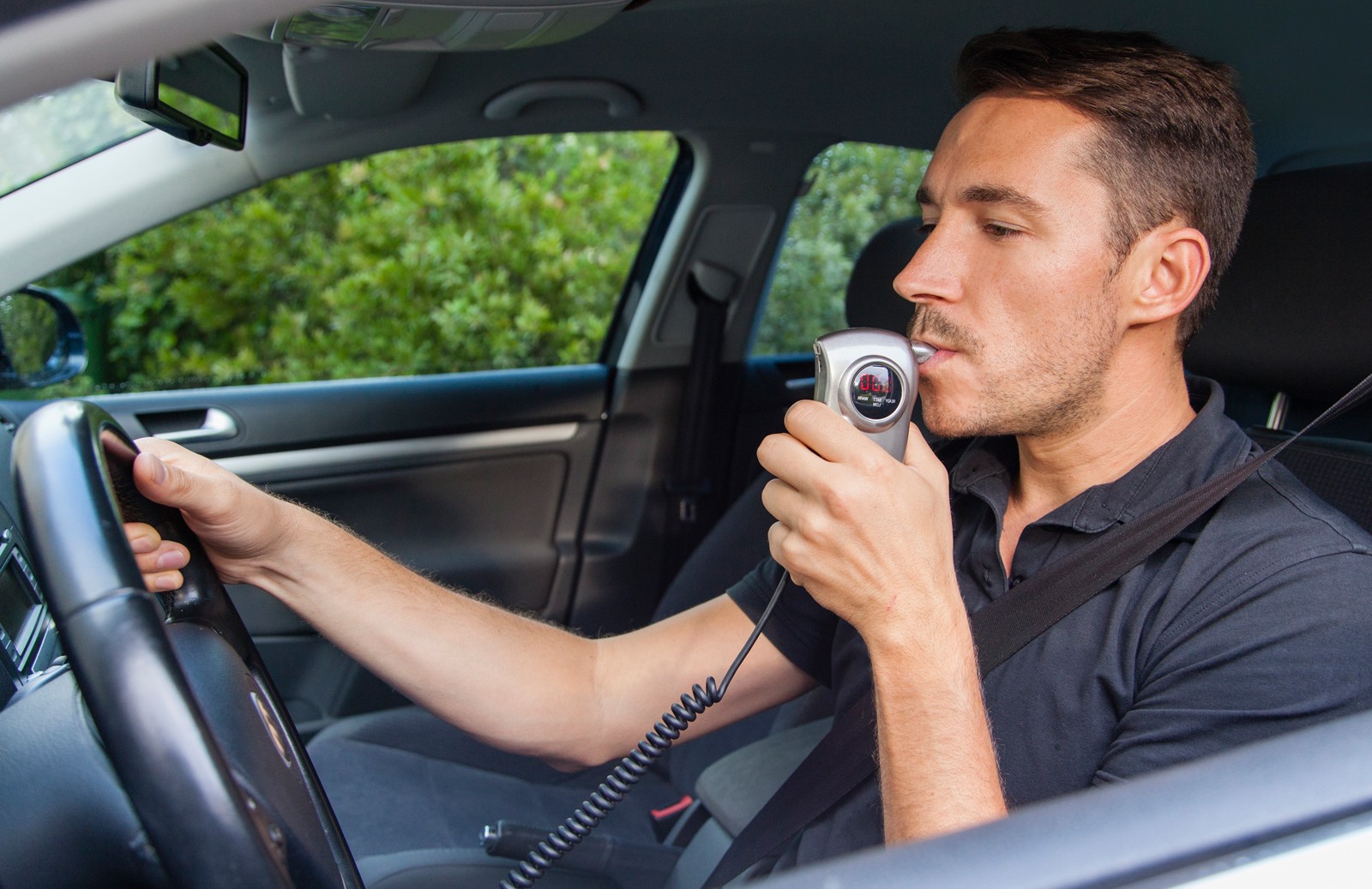 Man blowing into breathalyzer