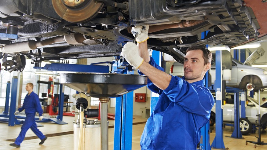 auto mechanic at car suspension repair work