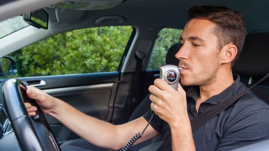 Man blowing into breathalyzer