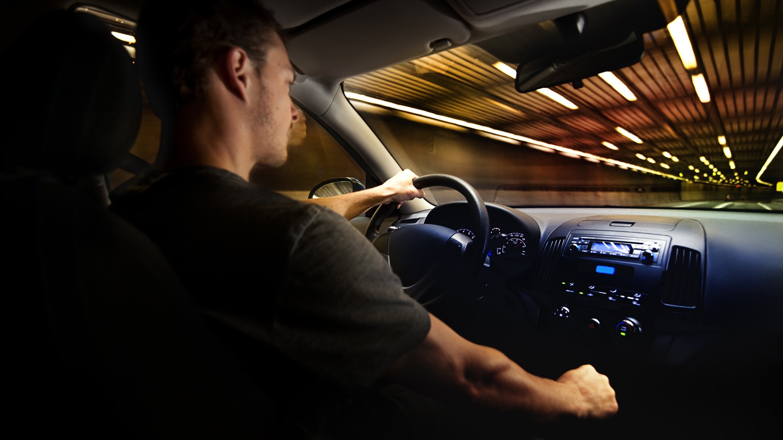 Young Adult Driving Over the Speed Limit in a Tunnel.