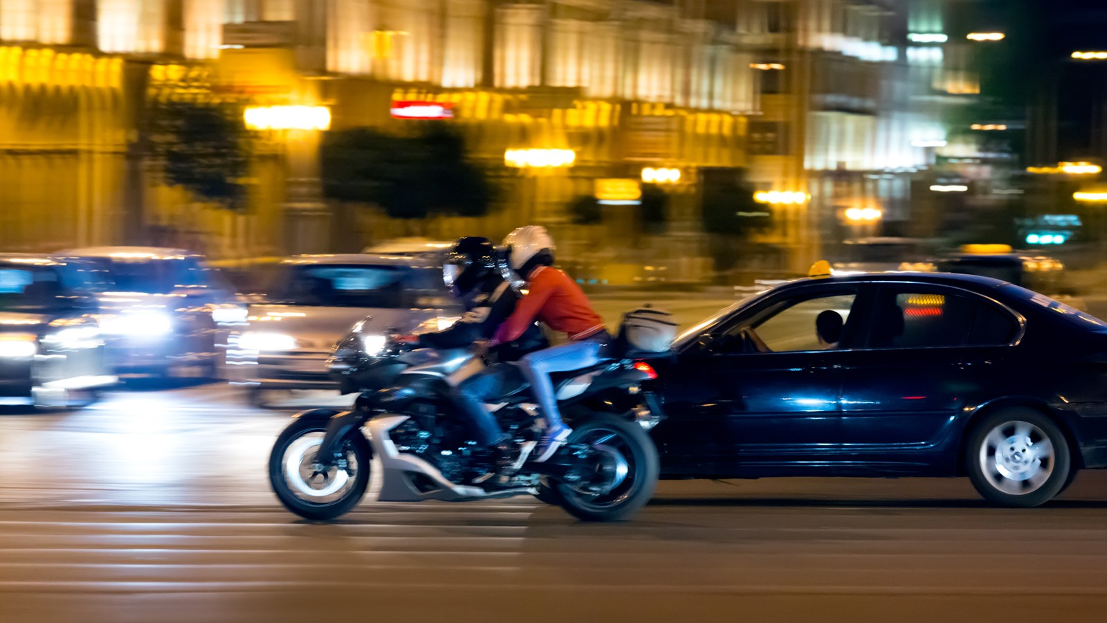 Motorcyclist on street at night