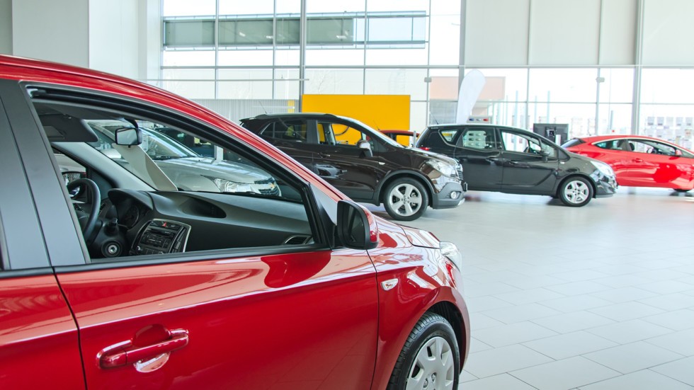 Several new cars at dealership salon.