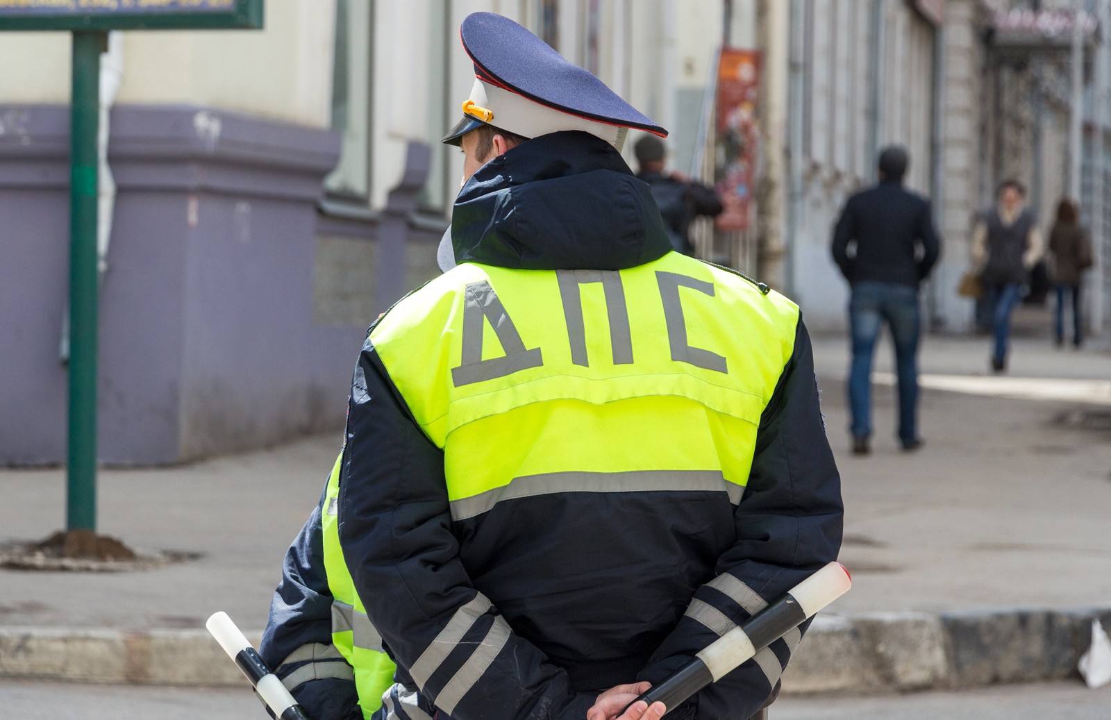 Russian police officers standing by the road in lime-colored uniform