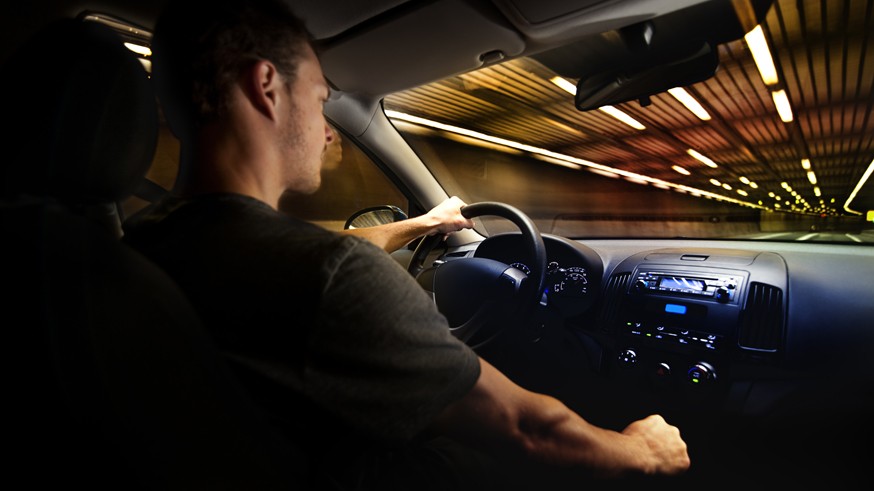 Young Adult Driving Over the Speed Limit in a Tunnel.