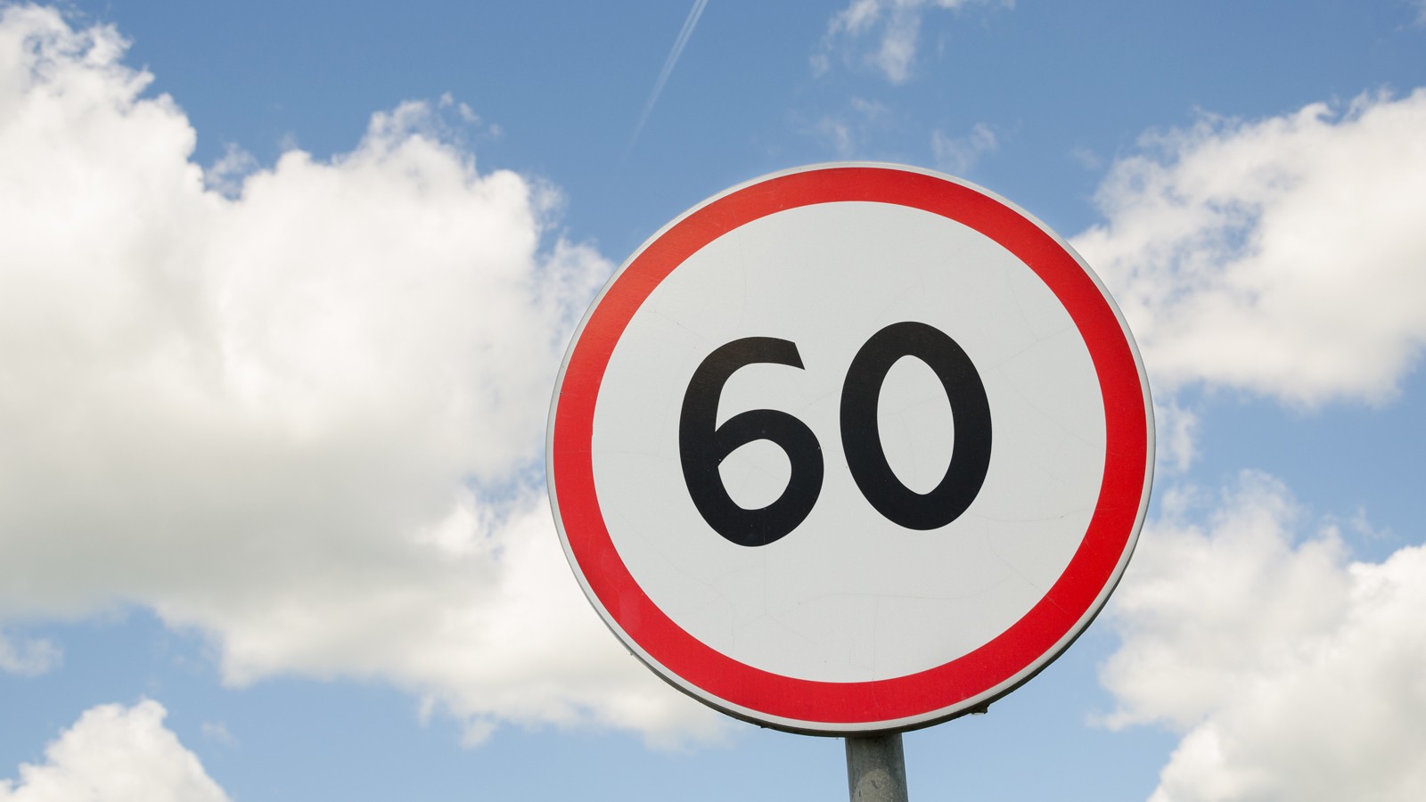 road traffic round sign limiting speed on blue sky