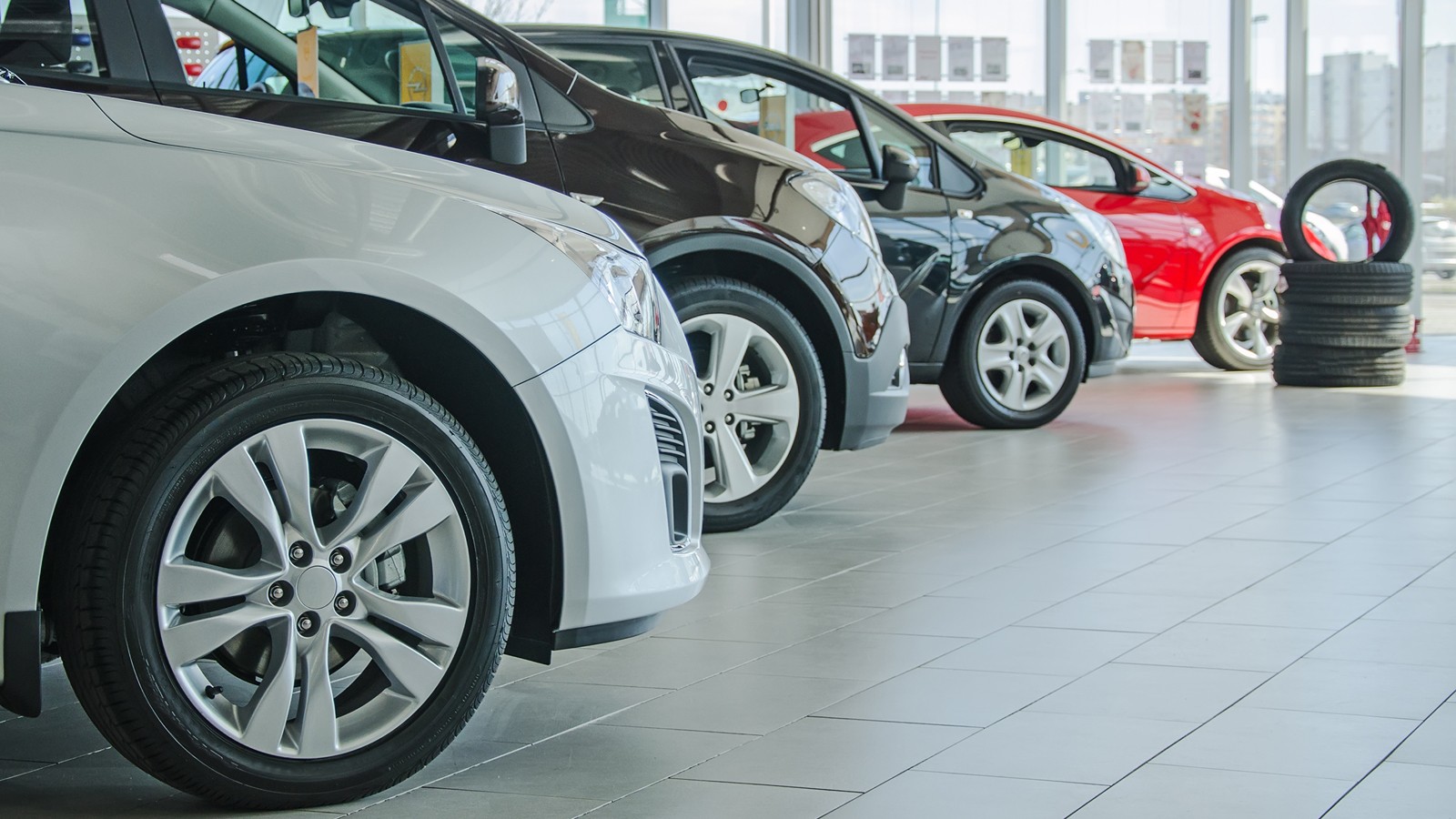 Several new cars at dealership salon.