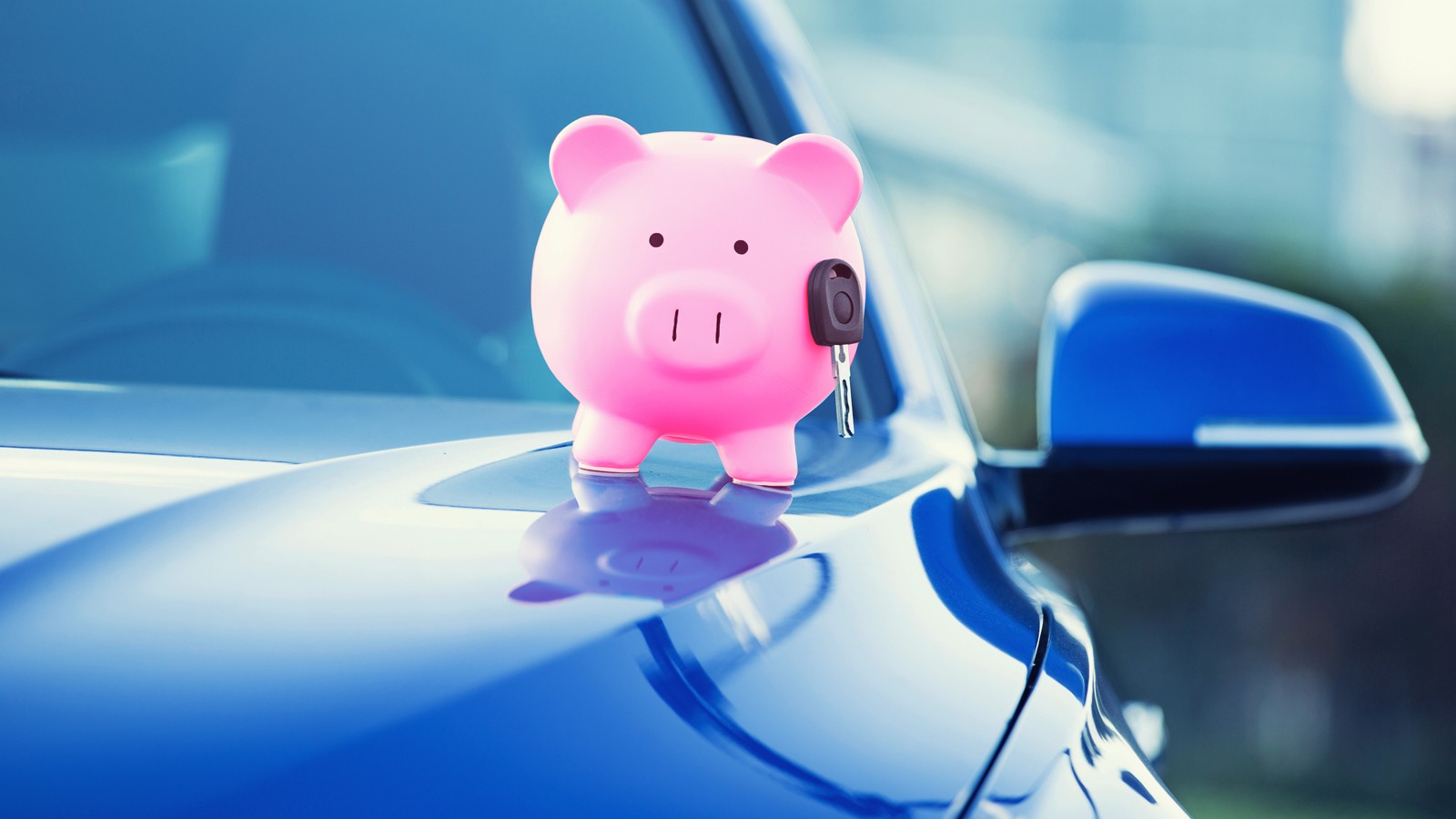 new car with piggy bank, key on hood