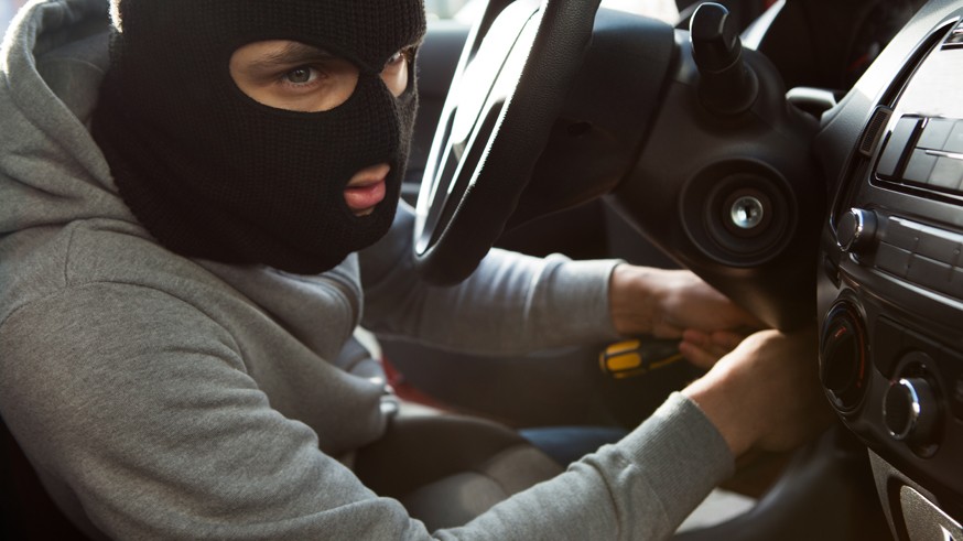 Thief Using Screwdriver In Car