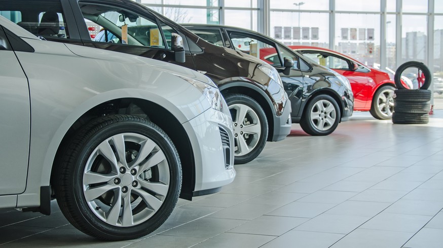 Several new cars at dealership salon.