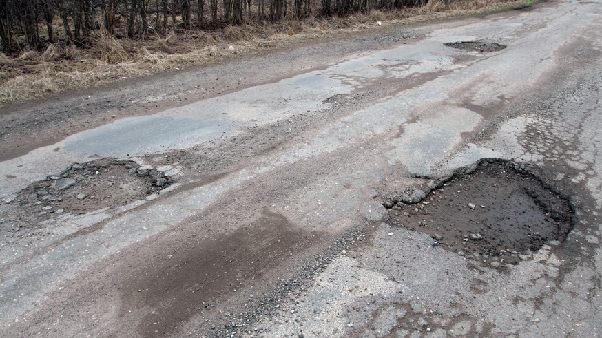 Damaged asphalt road after winter.