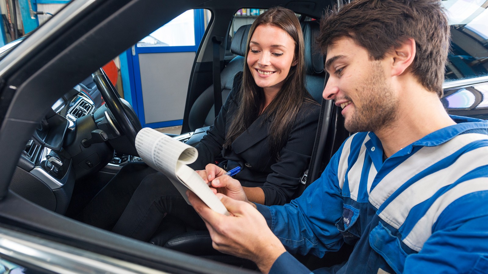Car mechanic with customer