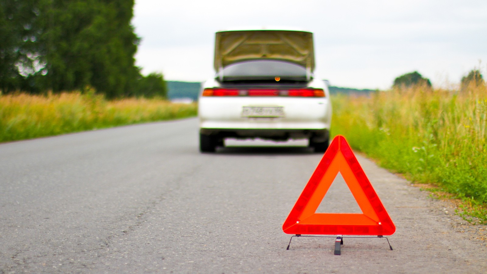 Red warning triangle with a broken down car
