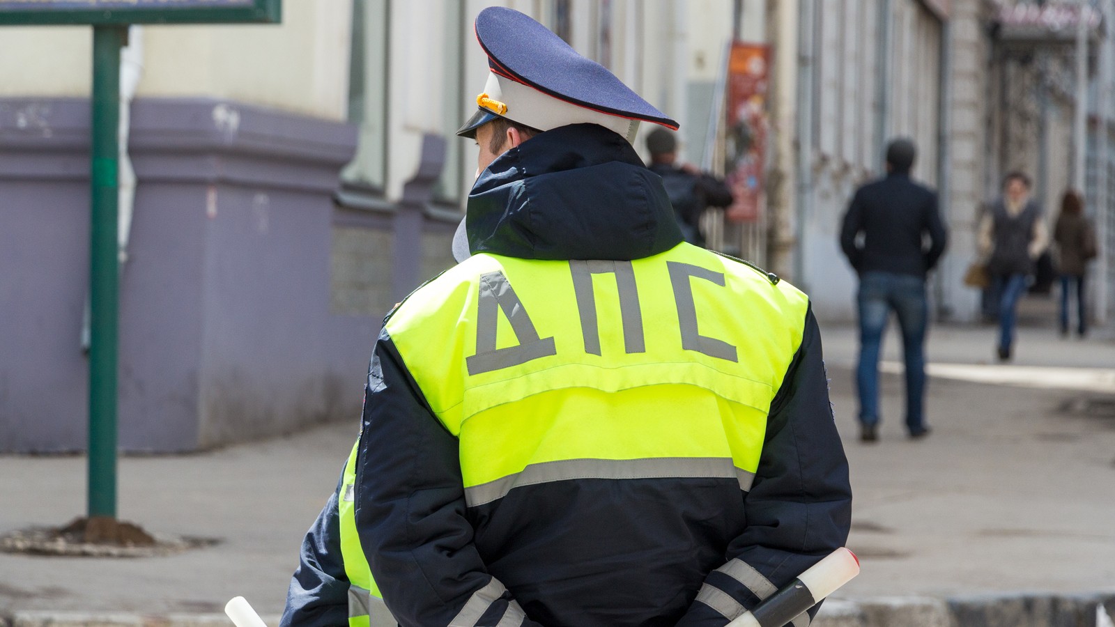 Russian police officers standing by the road in lime-colored uniform