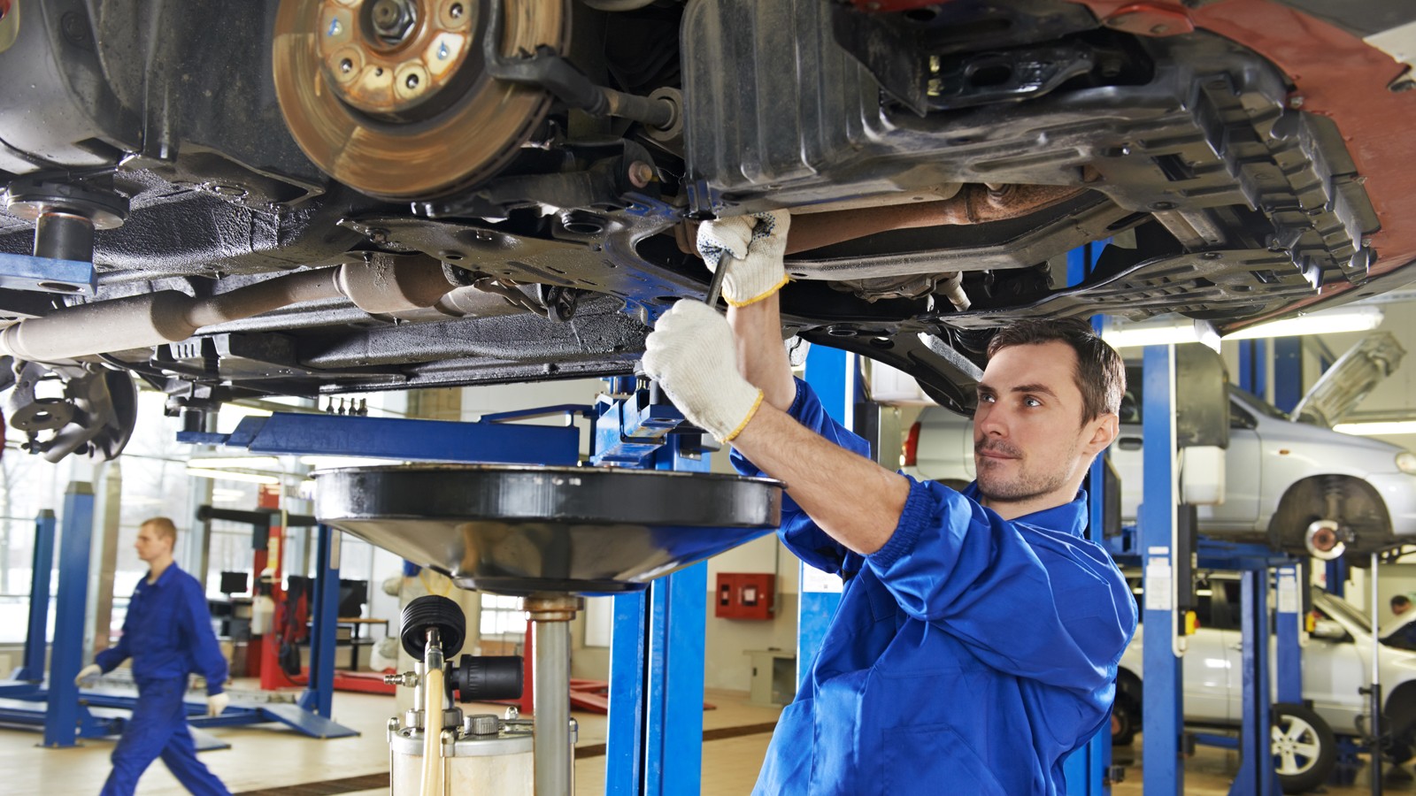 auto mechanic at car suspension repair work