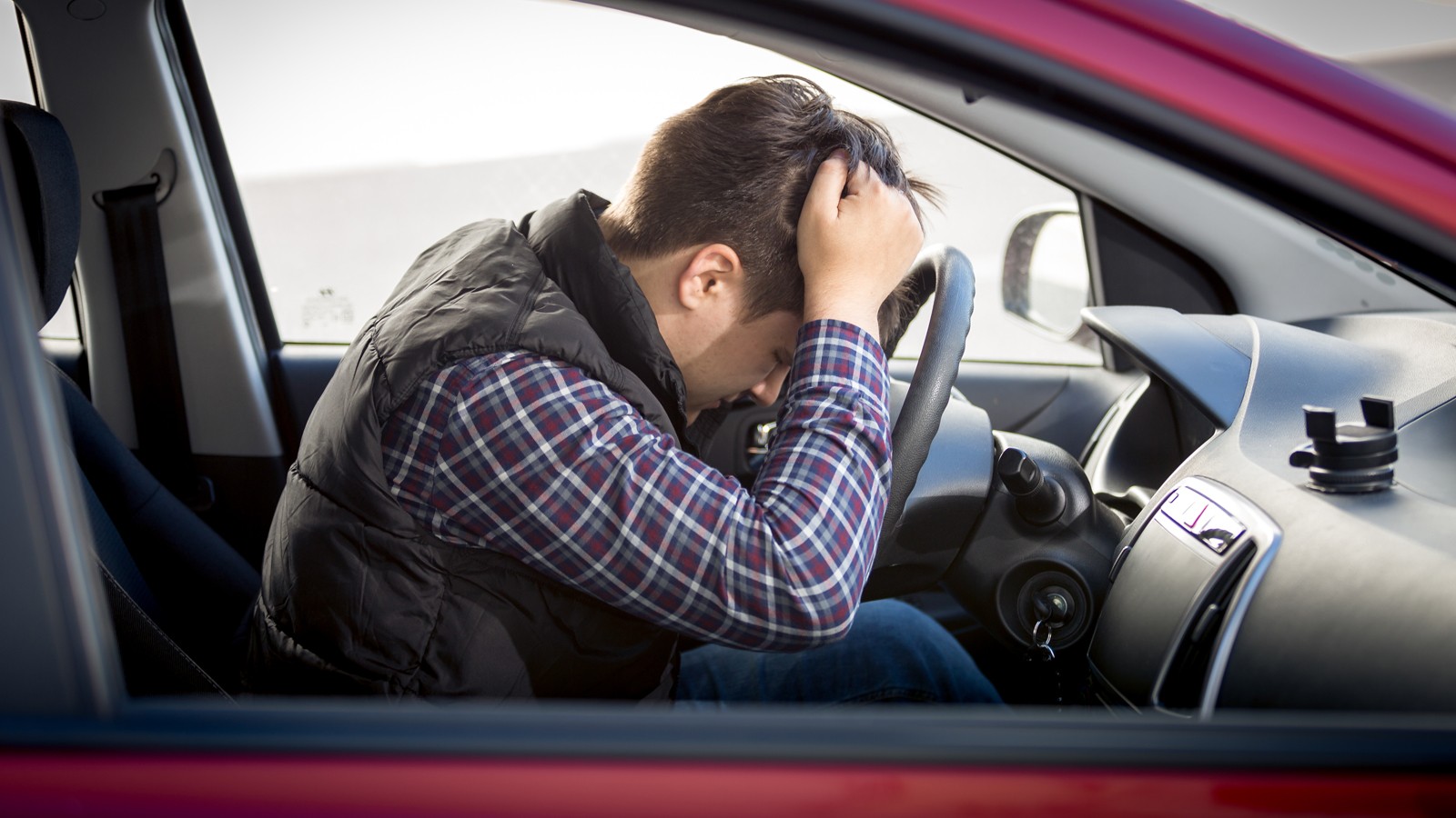 stressed man sitting on car drivers seat