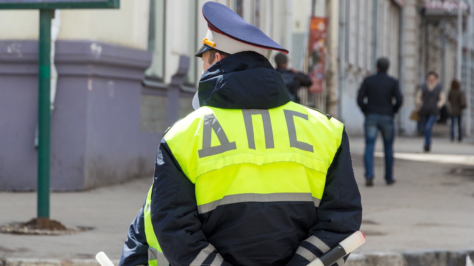 Russian police officers standing by the road in lime-colored uniform