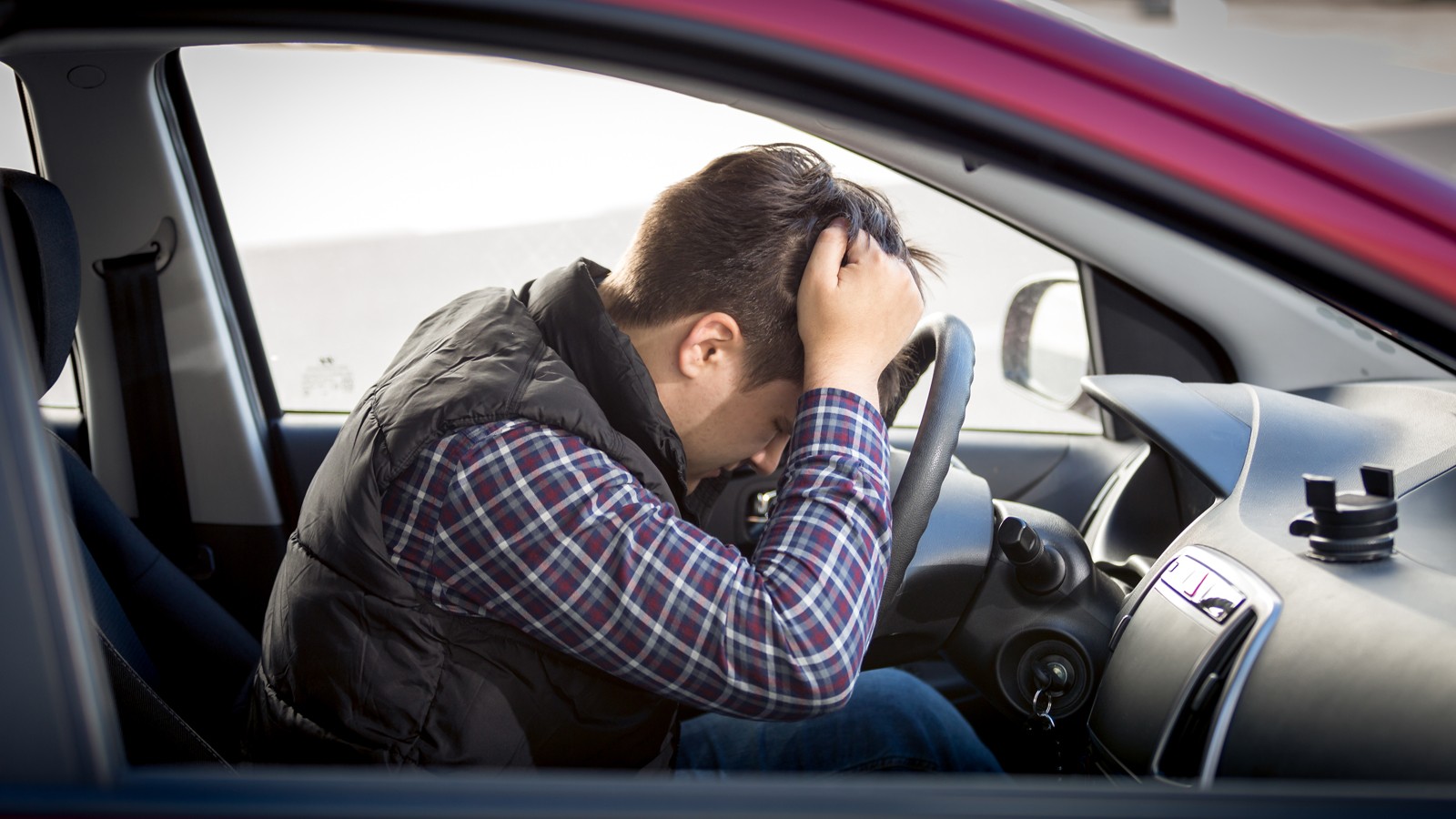 stressed man sitting on car drivers seat