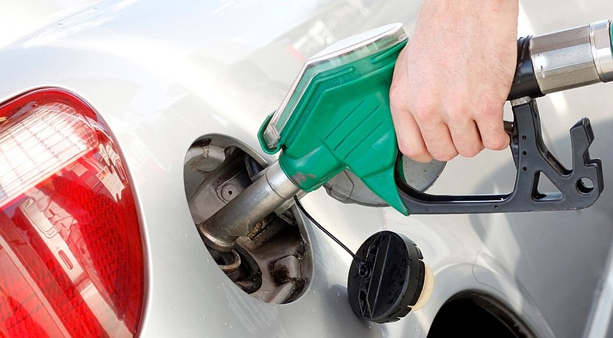 A man pumping gas in to the tank