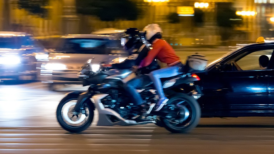 Motorcyclist on street at night
