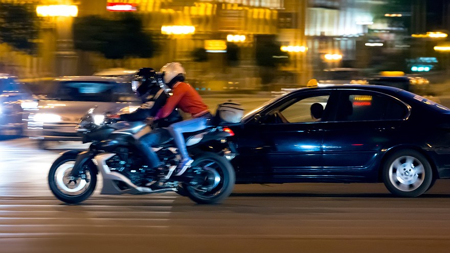Motorcyclist on street at night