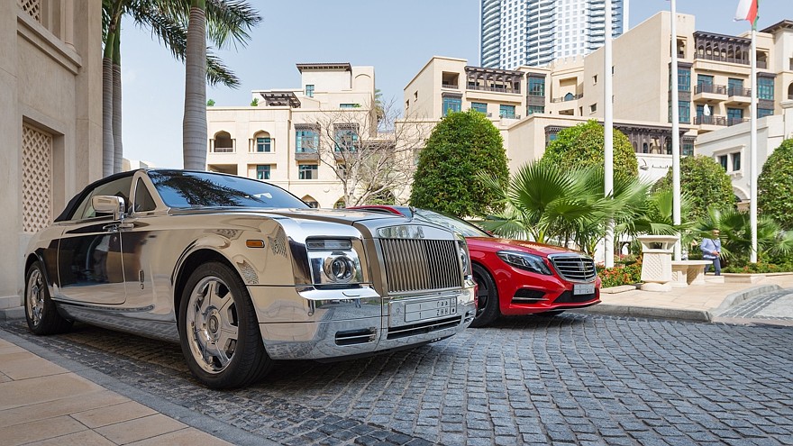 DUBAI, UAE — MARCH 30, 2014: Luxury car parked outside Palace Ho