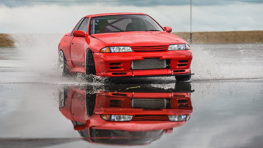 Nissan skyline R 32 red color on a wet road