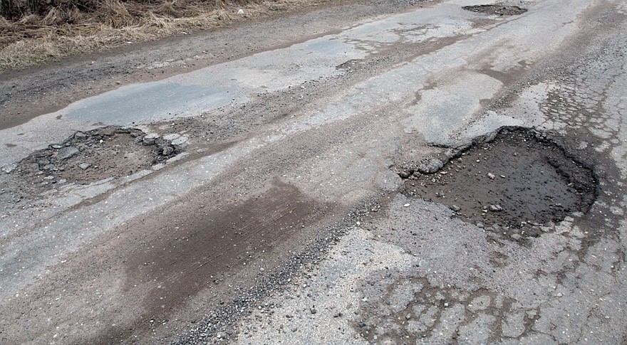 Damaged asphalt road after winter.