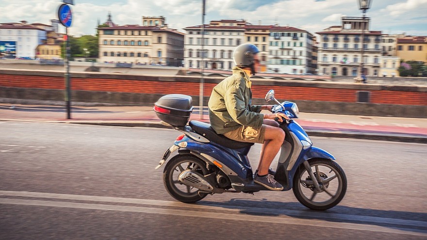 Boy racing motorbike in the streets of Florence
