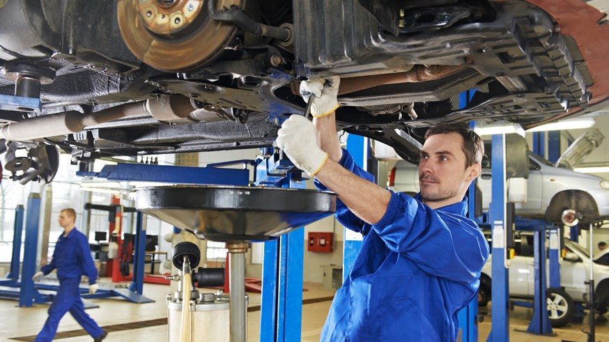 auto mechanic at car suspension repair work