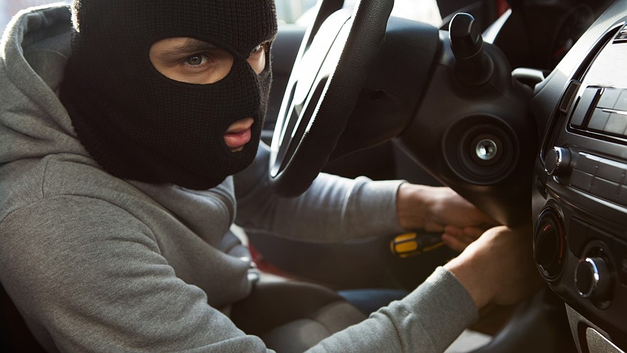 Thief Using Screwdriver In Car