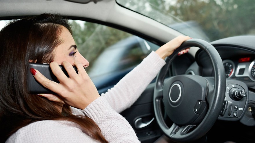 Woman talking on phone while driving