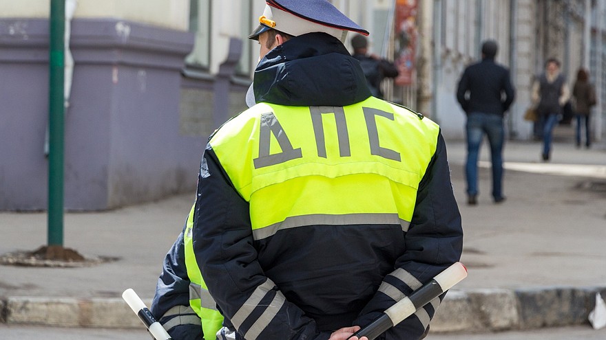 Russian police officers standing by the road in lime-colored uniform