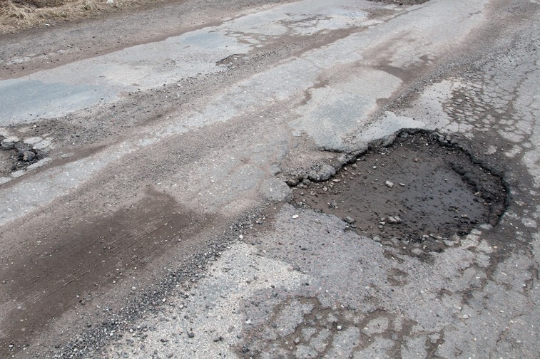 Damaged asphalt road after winter.